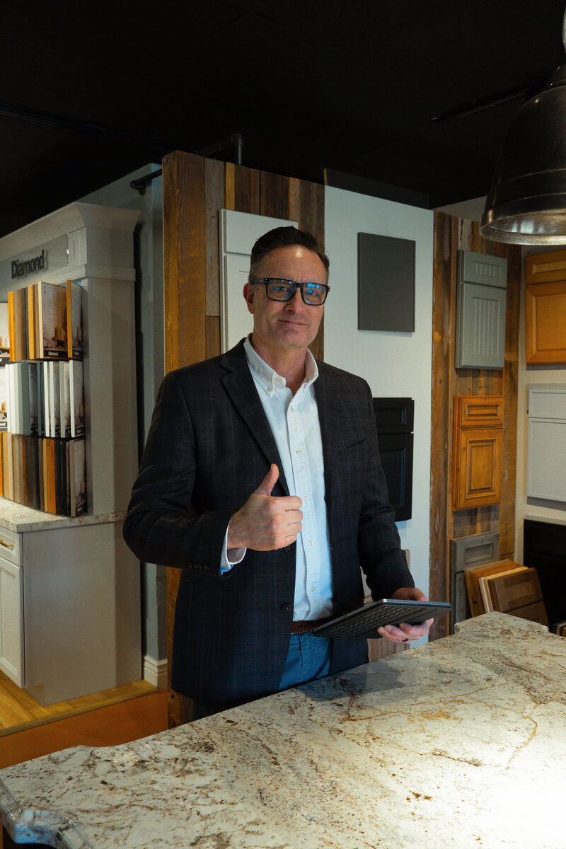 Designer reviewing plans at the California Cabinets showroom