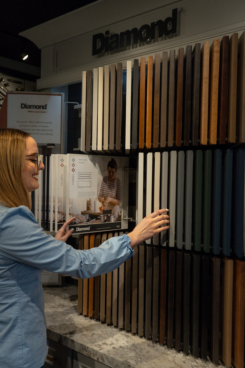 Designer selecting door styles and finishes at the Diamond display